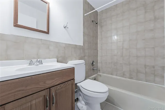 a bathroom with a sink toilet vanity and shower