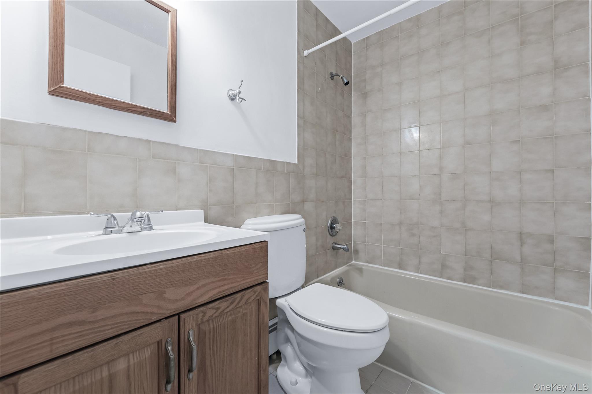 214-16 40th Avenue, Unit 3 Queens, NY 11361 - Photo 10 of 10 a bathroom with a sink toilet vanity and shower