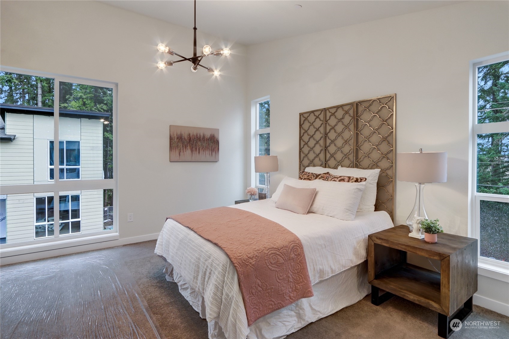 13710 Ash Way, Unit A7 Everett, WA 98204 - Photo 12 of 22 a bedroom with a bed and a chandelier