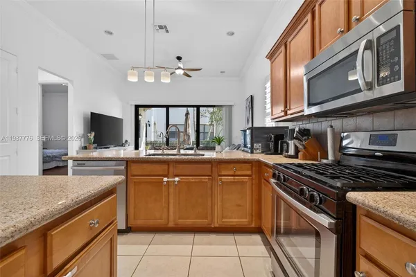 a kitchen with stainless steel appliances granite countertop a sink and a stove