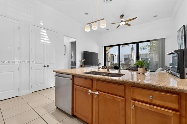 a kitchen with kitchen island a counter top space appliances and cabinets
