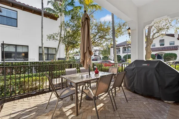 a view of a patio with couches table and chairs and potted plants