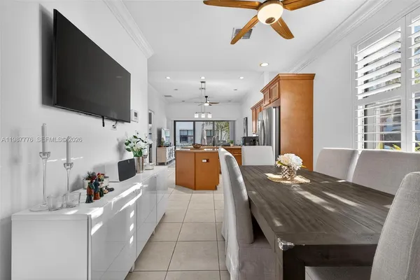 a dining room with furniture and a flat screen tv