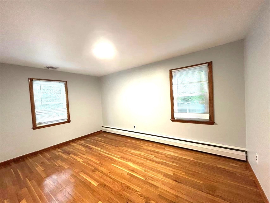 122 Running Brook Road Boston, MA 02132 - Photo 11 of 21 an empty room with a window