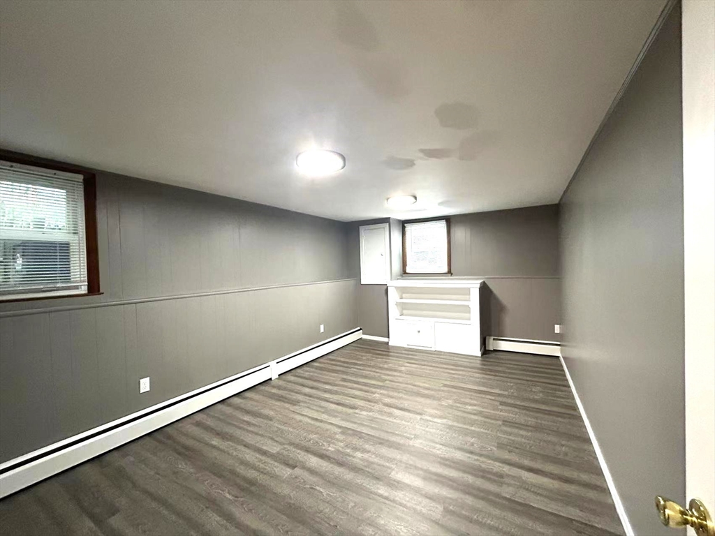 122 Running Brook Road Boston, MA 02132 - Photo 16 of 21 a view of an empty room with wooden floor and a window