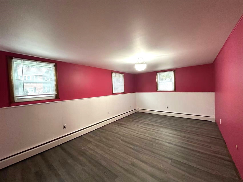 122 Running Brook Road Boston, MA 02132 - Photo 19 of 21 an empty room with wooden floor and windows
