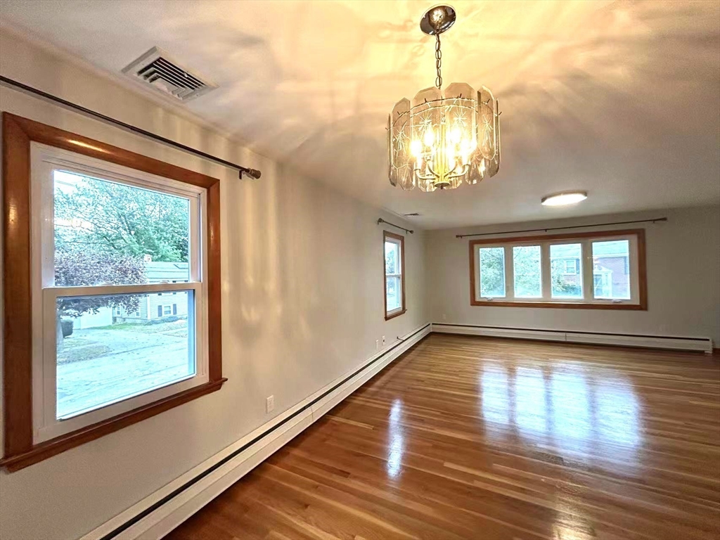 122 Running Brook Road Boston, MA 02132 - Photo 5 of 21 a view of empty room with wooden floor and fan