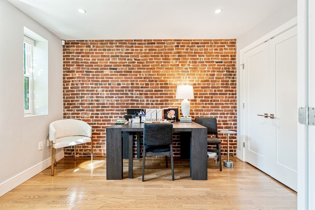 491 Massachusetts Avenue, Unit 1 Boston, MA 02118 - Photo 11 of 26 a work room with furniture and wooden floor