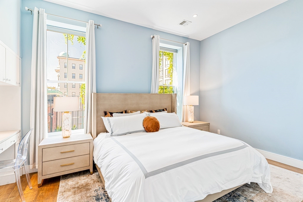 491 Massachusetts Avenue, Unit 1 Boston, MA 02118 - Photo 13 of 26 a bedroom with a bed and a window