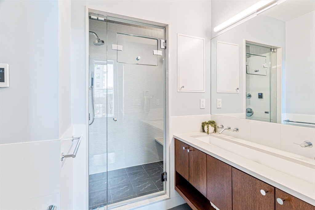 491 Massachusetts Avenue, Unit 1 Boston, MA 02118 - Photo 14 of 26 a bathroom with a double vanity sink and mirror