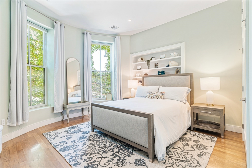 491 Massachusetts Avenue, Unit 1 Boston, MA 02118 - Photo 16 of 26 a bedroom with a large bed and a rug