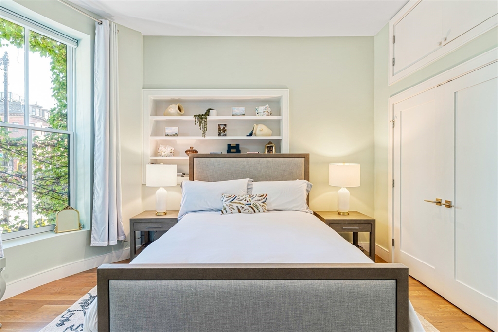 491 Massachusetts Avenue, Unit 1 Boston, MA 02118 - Photo 17 of 26 a bedroom with a bed and a window