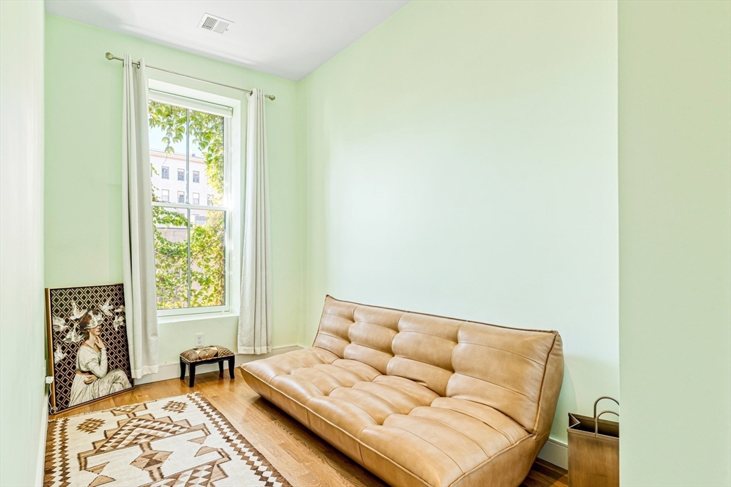 491 Massachusetts Avenue, Unit 1 Boston, MA 02118 - Photo 19 of 26 a living room with furniture and a window