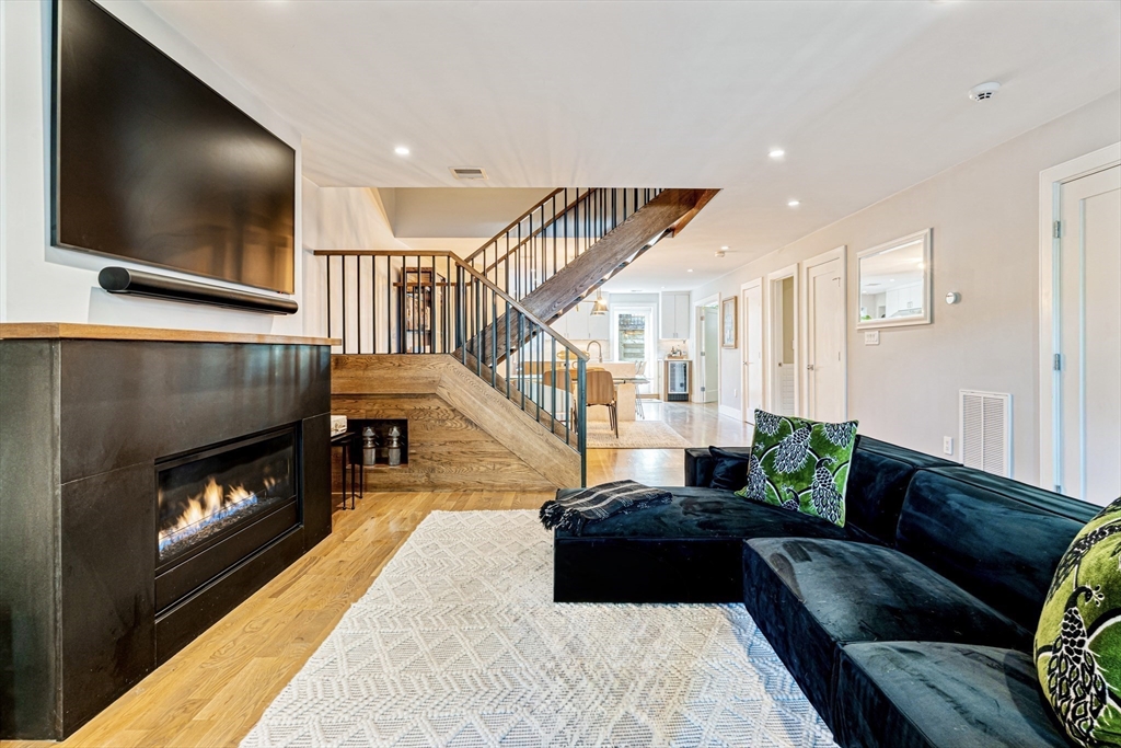 491 Massachusetts Avenue, Unit 1 Boston, MA 02118 - Photo 2 of 26 a living room with furniture and a fireplace
