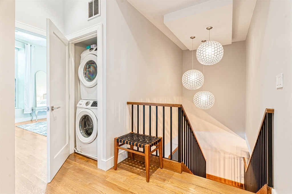 491 Massachusetts Avenue, Unit 1 Boston, MA 02118 - Photo 21 of 26 a view of a hallway with washer and dryer