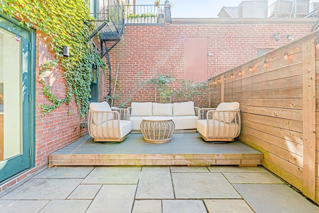 491 Massachusetts Avenue, Unit 1 Boston, MA 02118 - Photo 23 of 26 a view of a chairs and table in the patio