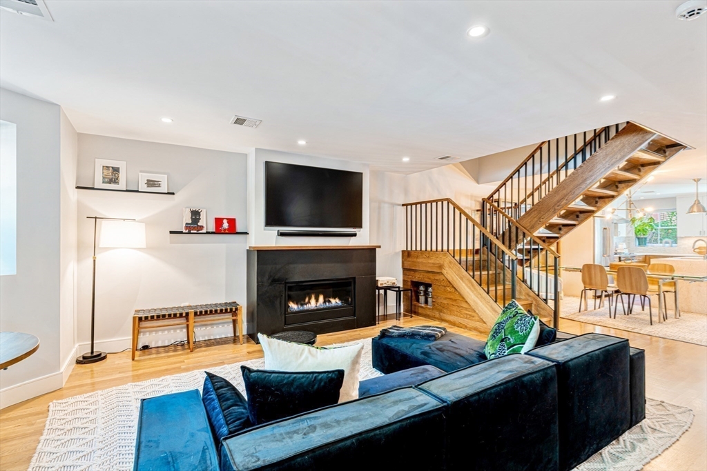491 Massachusetts Avenue, Unit 1 Boston, MA 02118 - Photo 3 of 26 a living room with furniture a fireplace and a flat screen tv
