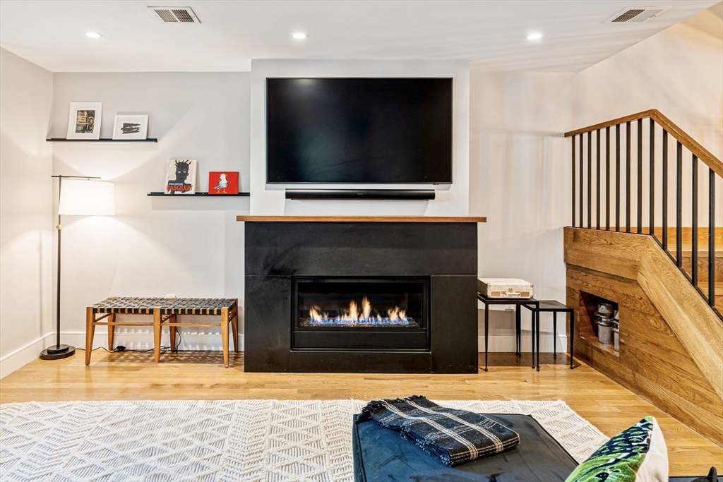 491 Massachusetts Avenue, Unit 1 Boston, MA 02118 - Photo 4 of 26 a living room with furniture and a fireplace