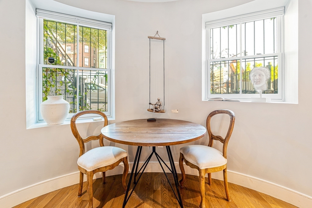 491 Massachusetts Avenue, Unit 1 Boston, MA 02118 - Photo 6 of 26 a view of a a dining room with furniture window and wooden floor