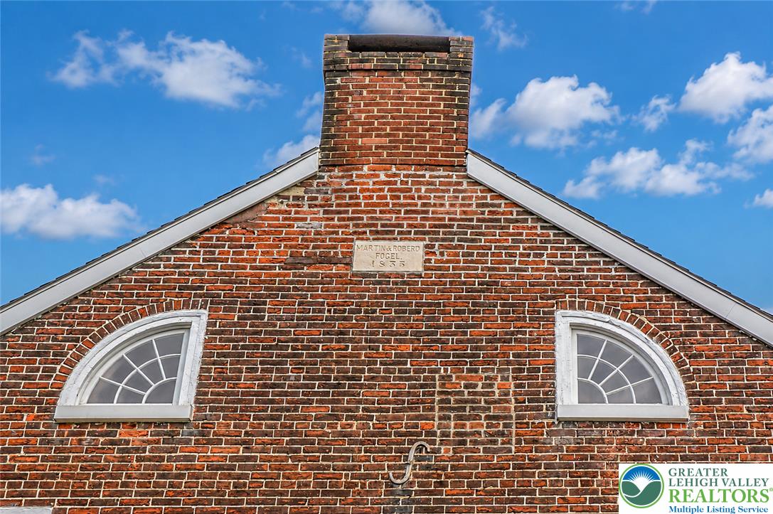 1742 Butztown Road Bethlehem, PA 18017 - Photo 3 of 56 Original arched attic windows and an 1855 date stone showcase the home's enduring architectural details