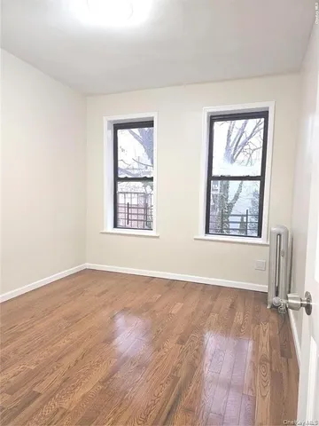 an empty room with windows and closet
