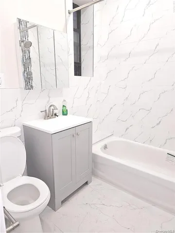 a bathroom with a bathtub and a sink