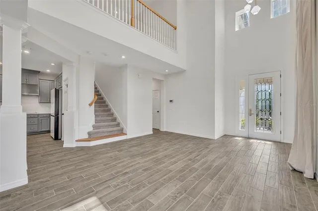 an empty room with windows and entrance