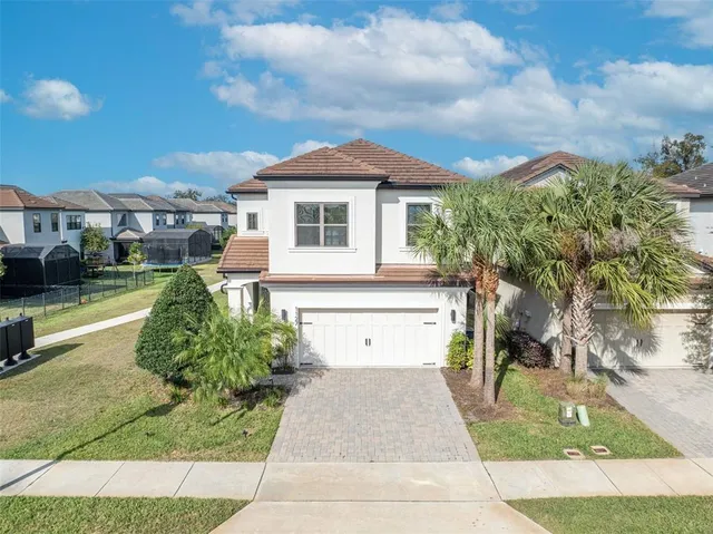 a view of an empty room with wooden floor and a bathroom