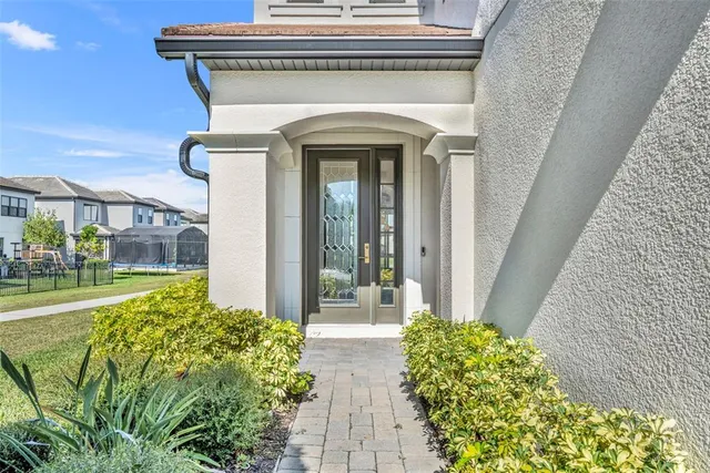 a dining room with furniture a chandelier and wooden floor