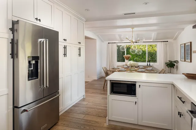 a kitchen with stainless steel appliances a refrigerator sink and cabinets