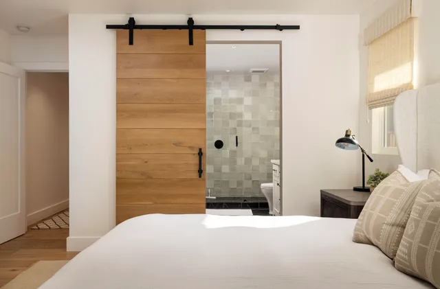 a bedroom with a bed and a shower