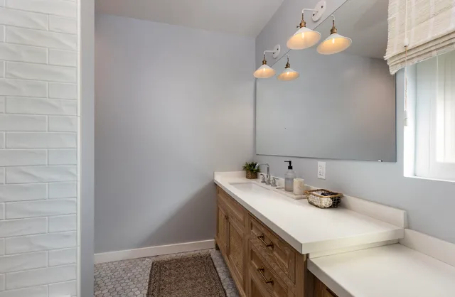 a bathroom with a sink vanity and a mirror