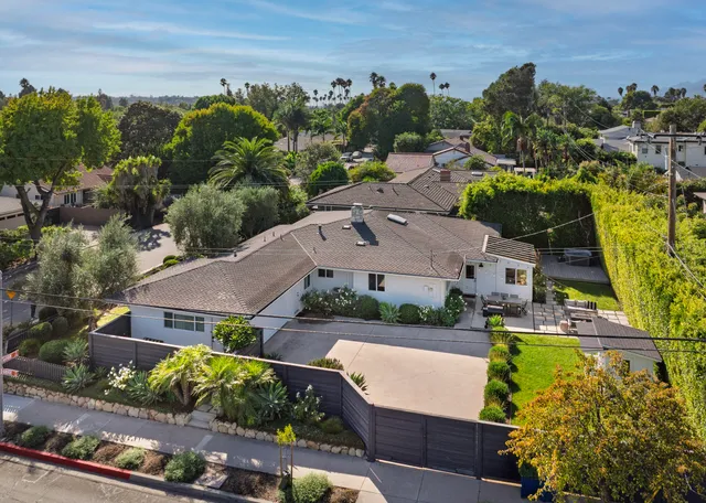 an aerial view of multiple houses with yard