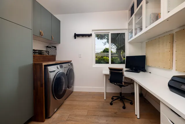 a view of a workspace with furniture and a window