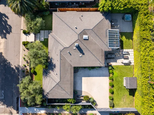 an aerial view of a house with swimming pool and porch