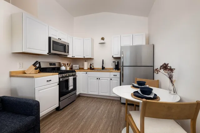 a kitchen with a sink a stove and refrigerator