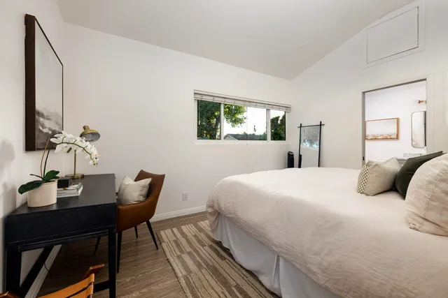 a bedroom with a bed and a table