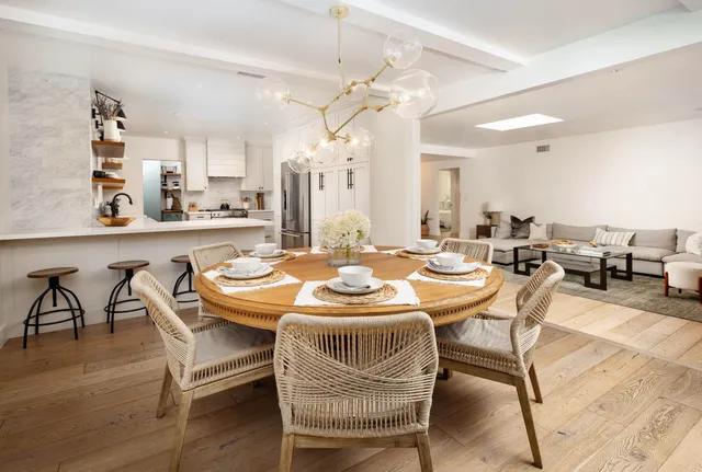 a dining room with furniture and wooden floor