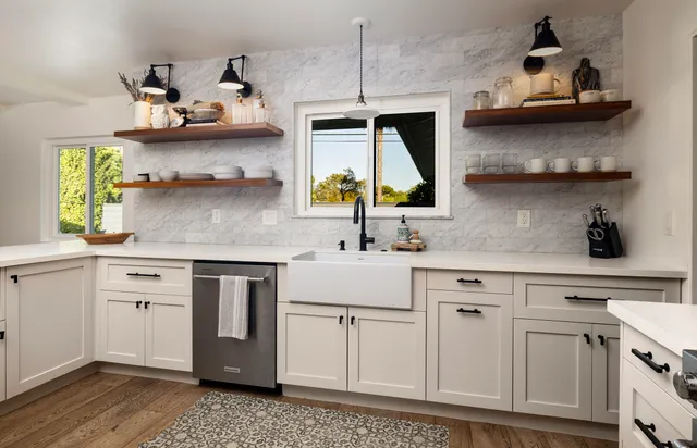 a kitchen with stainless steel appliances white cabinets and a sink