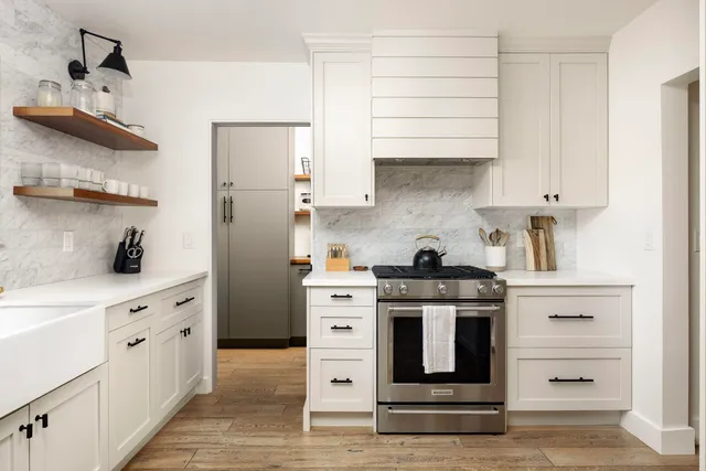 a kitchen with stainless steel appliances granite countertop a stove and a refrigerator