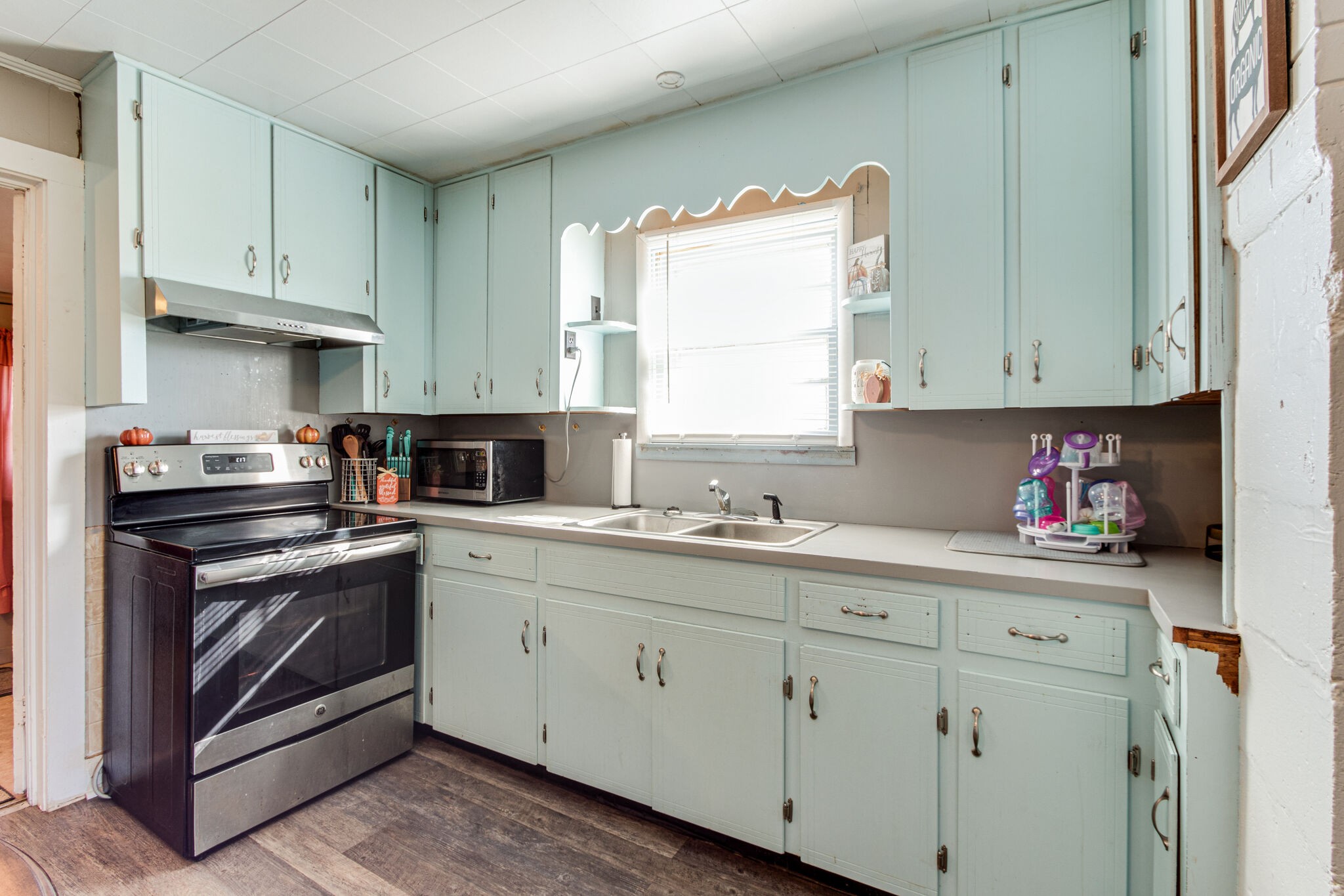 8026 Fredonia Road Manchester, TN 37355 - Photo 11 of 26 a kitchen with stainless steel appliances granite countertop a sink and cabinets with wooden floor