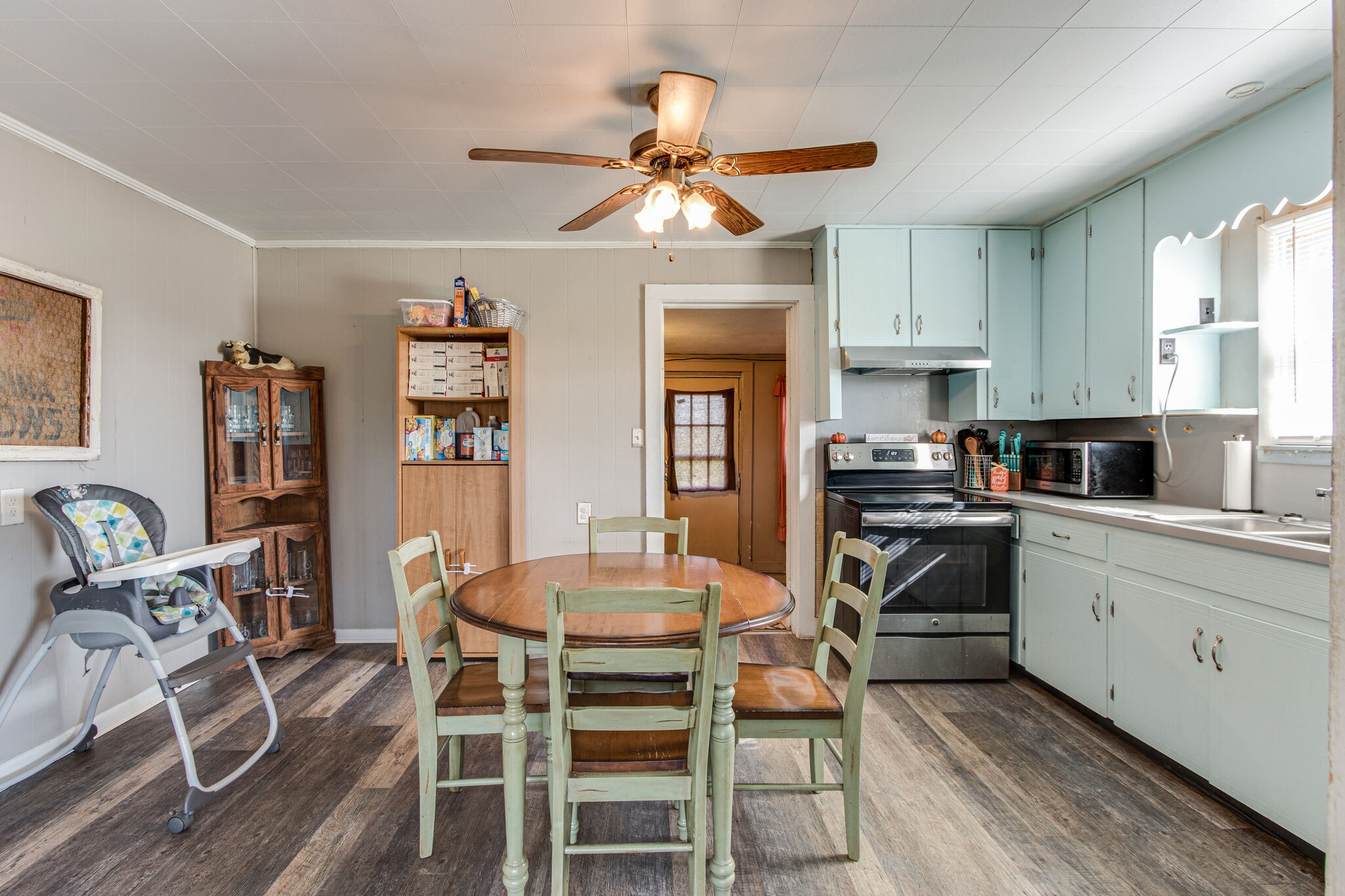 8026 Fredonia Road Manchester, TN 37355 - Photo 9 of 26 a kitchen with stainless steel appliances a dining table chairs refrigerator and sink