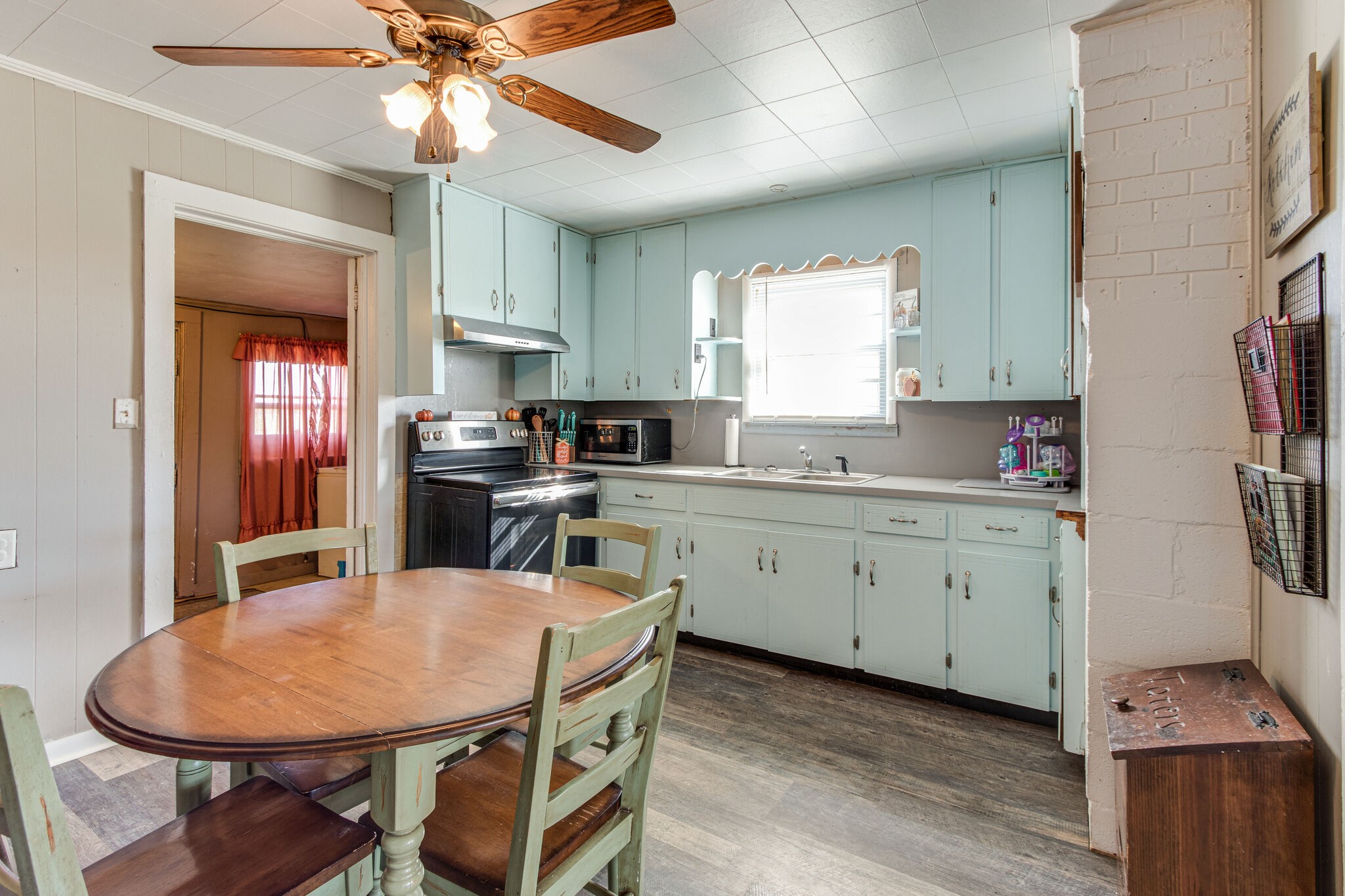 8026 Fredonia Road Manchester, TN 37355 - Photo 10 of 26 a kitchen with stainless steel appliances granite countertop a sink a stove a refrigerator a dining table and chairs with wooden floor