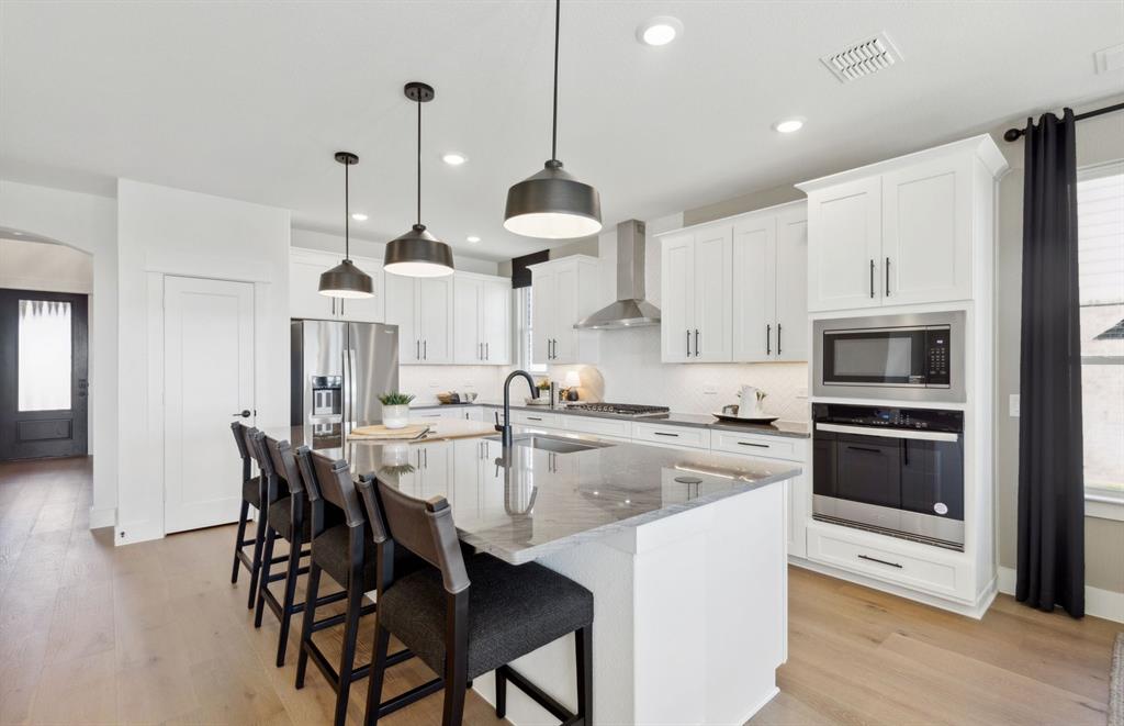 4729 Ripley Court Celina, TX 75009 - Photo 3 of 16 *Model Representation - Spacious kitchen with eat-in bartop island
