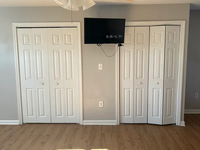 a view of staircase with wooden floor and window