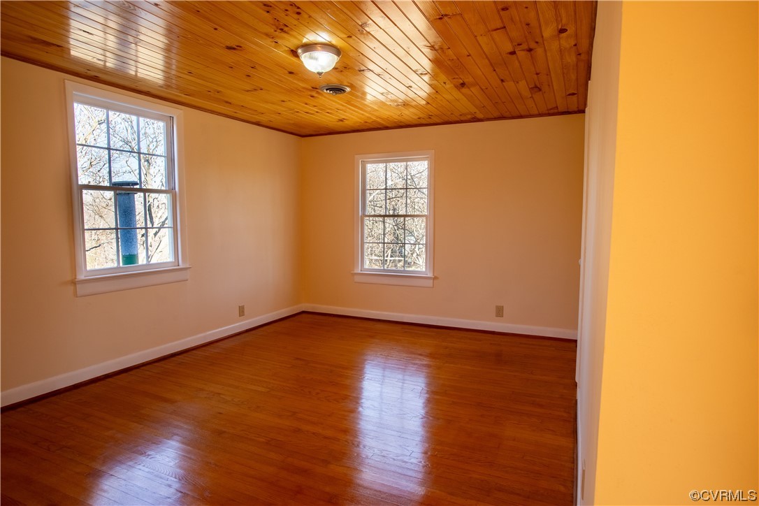 1431 Three Chopt Road Kents Store, VA 23084 - Photo 27 of 40 an empty room with wooden floor and windows