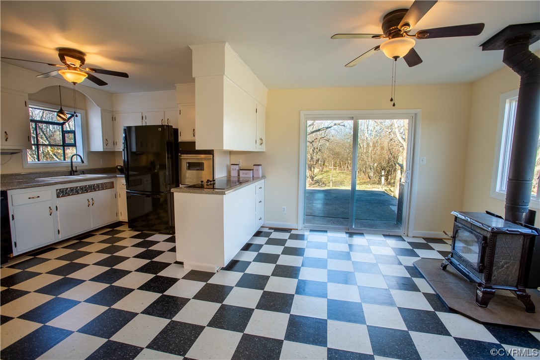 1431 Three Chopt Road Kents Store, VA 23084 - Photo 10 of 40 a kitchen with a checkered floor and a black appliances