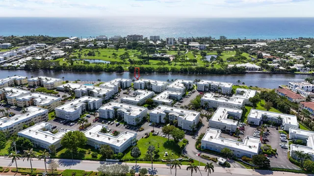 an aerial view of a city with lots of residential buildings lake and ocean view