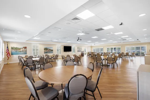 a dining room with furniture window and wooden floor