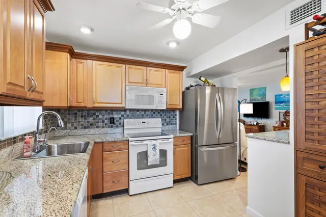 a kitchen with a refrigerator sink and cabinets
